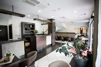 a restaurant with chairs and tables and a bar at Hotel Mangart in Bovec