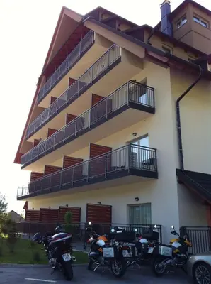 a group of motorcycles parked in front of a building at Hotel Mangart in Bovec