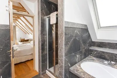 a bathroom with a shower and a sink at Lesar Hotel Angel - Member of Hip Hotels in Ljubljana