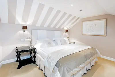 a bedroom with a large bed with white sheets at Lesar Hotel Angel - Member of Hip Hotels in Ljubljana