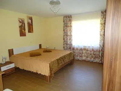 a bedroom with a bed and a window with curtains at Atera in Banovci