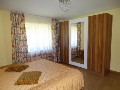 a bedroom with a large bed and a mirror at Atera in Banovci