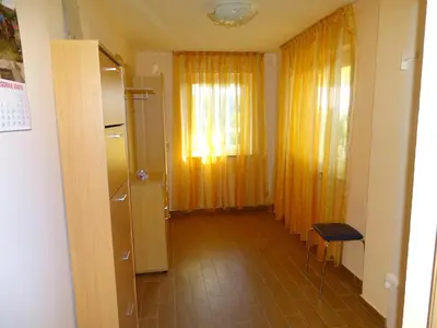 a room with a door and a window and a table at Atera in Banovci