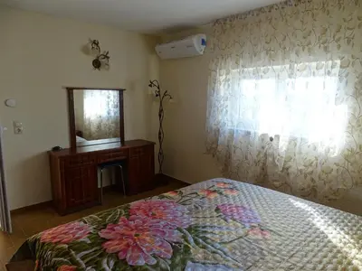a bedroom with a bed and a mirror and a dresser at Atera in Banovci