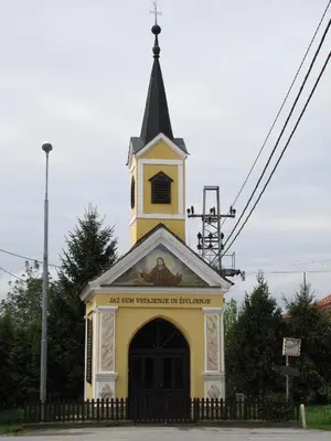 a small church with a steeple on top of it at Atera in Banovci