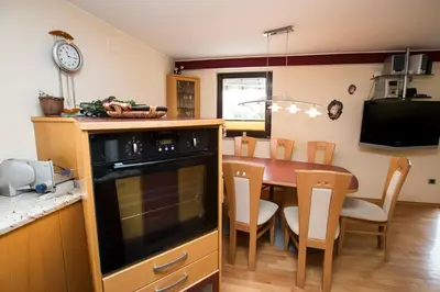 a kitchen with a table and a dining room at Holiday House Klemenčič in Bohinj
