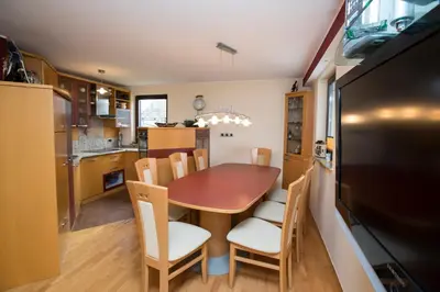 a kitchen and dining room with a table and chairs at Holiday House Klemenčič in Bohinj