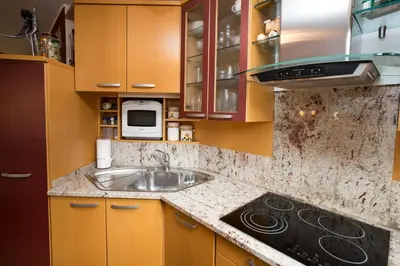 a kitchen with a sink and a microwave at Holiday House Klemenčič in Bohinj