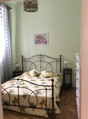 a bedroom with a bed in a room with green walls at Vila Rogaška in Rogaška Slatina