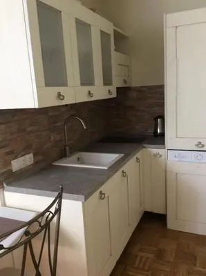 a kitchen with white cabinets and a sink at Vila Rogaška in Rogaška Slatina