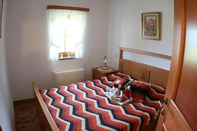 a bedroom with a bed with two stuffed animals on it at Zidanica Ravbar in Uršna Sela