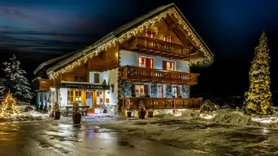 a building with christmas lights in front of it at Apartments in Villa Flora in Kranjska Gora