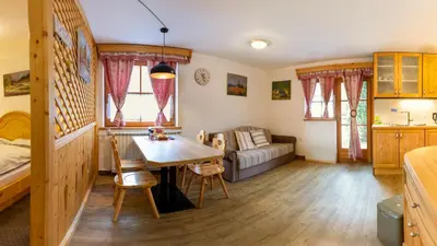 a living room with a table and a couch at Apartments in Villa Flora in Kranjska Gora