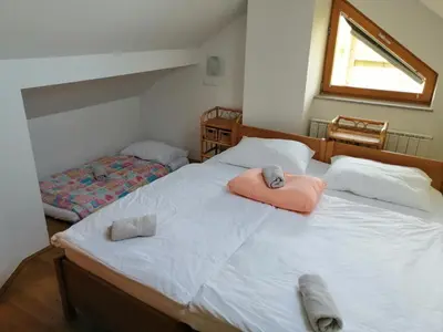 a bedroom with two beds with towels on them at Guest House Eco Vila Mila in Rogaška Slatina