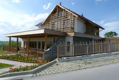 a house with a fence in front of it at Guest House Eco Vila Mila in Rogaška Slatina