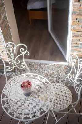 a table and chairs with a bowl of fruit on it at Cute sunny apartment KOD1 in Ljubljana