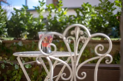 a white table with a cup on top of it at Cute sunny apartment KOD1 in Ljubljana