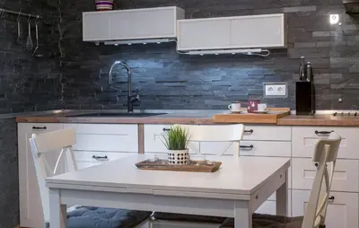 a kitchen with a white table and a sink at Cute sunny apartment KOD1 in Ljubljana