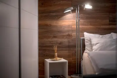 a bedroom with a bed and a lamp on a table at Cute sunny apartment KOD1 in Ljubljana