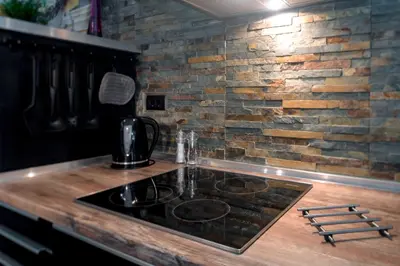 a kitchen with a counter top with a stove at Cute sunny apartment KOD1 in Ljubljana