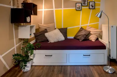 a couch with pillows on it in a room at Cute sunny apartment KOD1 in Ljubljana