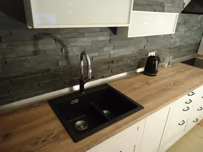 a kitchen with a sink and a wooden counter at Cute sunny apartment KOD1 in Ljubljana