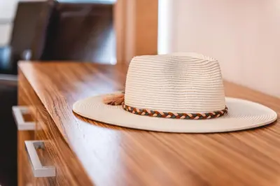 a hat sitting on top of a wooden table at Casino & Hotel ADMIRAL Kozina in Kozina