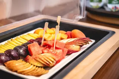 a tray of different types of fruit on a table at Casino & Hotel ADMIRAL Kozina in Kozina