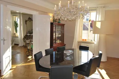 a dining room with a black table and black chairs at Neoclassical Luxury Apartment Ljubljana in Ljubljana