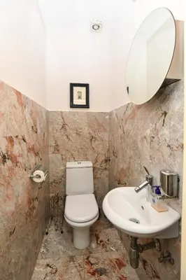 a bathroom with a sink and a toilet and a mirror at Neoclassical Luxury Apartment Ljubljana in Ljubljana