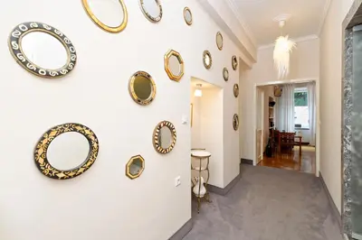 a hallway with gold plates on the wall at Neoclassical Luxury Apartment Ljubljana in Ljubljana