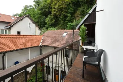 a balcony with two chairs and a table on it at Neoclassical Luxury Apartment Ljubljana in Ljubljana