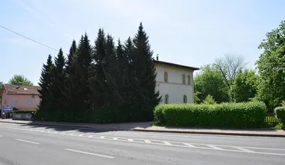 a house on the side of a street with trees at Guesthouse Soul in Ljubljana