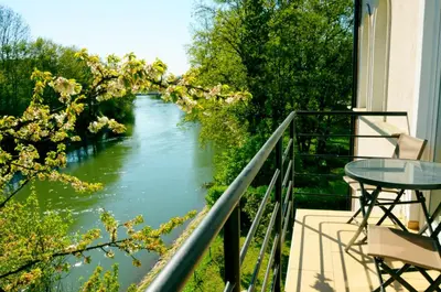 a balcony with a view of a river at Guesthouse Soul in Ljubljana