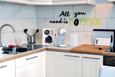 a kitchen counter with a sink and a sign that reads all you needs coffee at Guesthouse Soul in Ljubljana