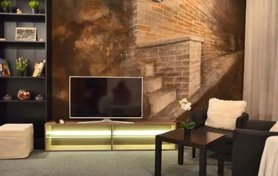 a living room with a television on a wall at Guesthouse Soul in Ljubljana