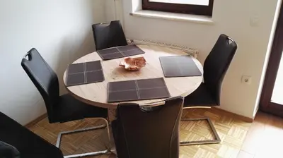 a cat sitting on top of a wooden table at Apartment Šija in Bohinj