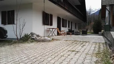a patio of a house with a table and chairs at Apartment Šija in Bohinj