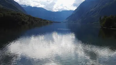 a large body of water with mountains in the background at Apartment Šija in Bohinj