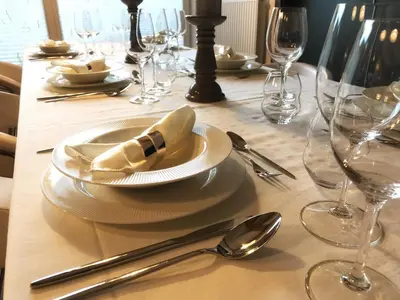 a table with a white plate and silverware on it at Bled Apartment Kirsch in Bled