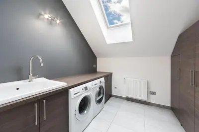 a laundry room with a sink and a washing machine at Bled Apartment Kirsch in Bled