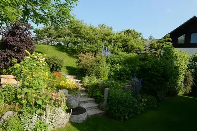 a garden with many different flowers and plants at Bled Apartment Kirsch in Bled