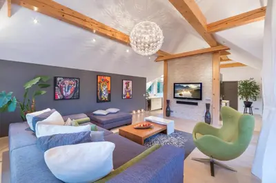 a living room with a blue couch and a fireplace at Bled Apartment Kirsch in Bled