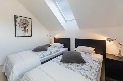 two beds in a attic bedroom with a skylight at Bled Apartment Kirsch in Bled