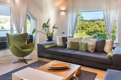 a living room with a couch and a chair at Bled Apartment Kirsch in Bled