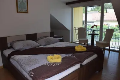 a bedroom with a bed with yellow towels on it at Hostel Novak in Novo Mesto