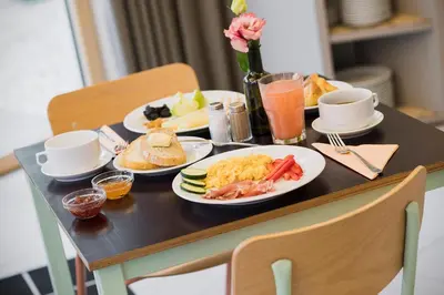 a breakfast table with plates of food and drinks at Art Hotel in Ljubljana