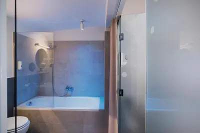 a bathroom with a tub and a toilet at Art Hotel in Ljubljana