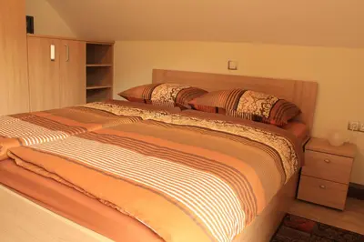 a bed with two pillows on it in a bedroom at Apartments Villa Dov in Bohinj