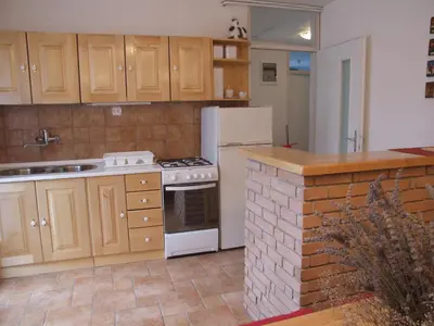a kitchen with a white refrigerator and a stove at Apartment Mlinarjeva domačija in Kobarid